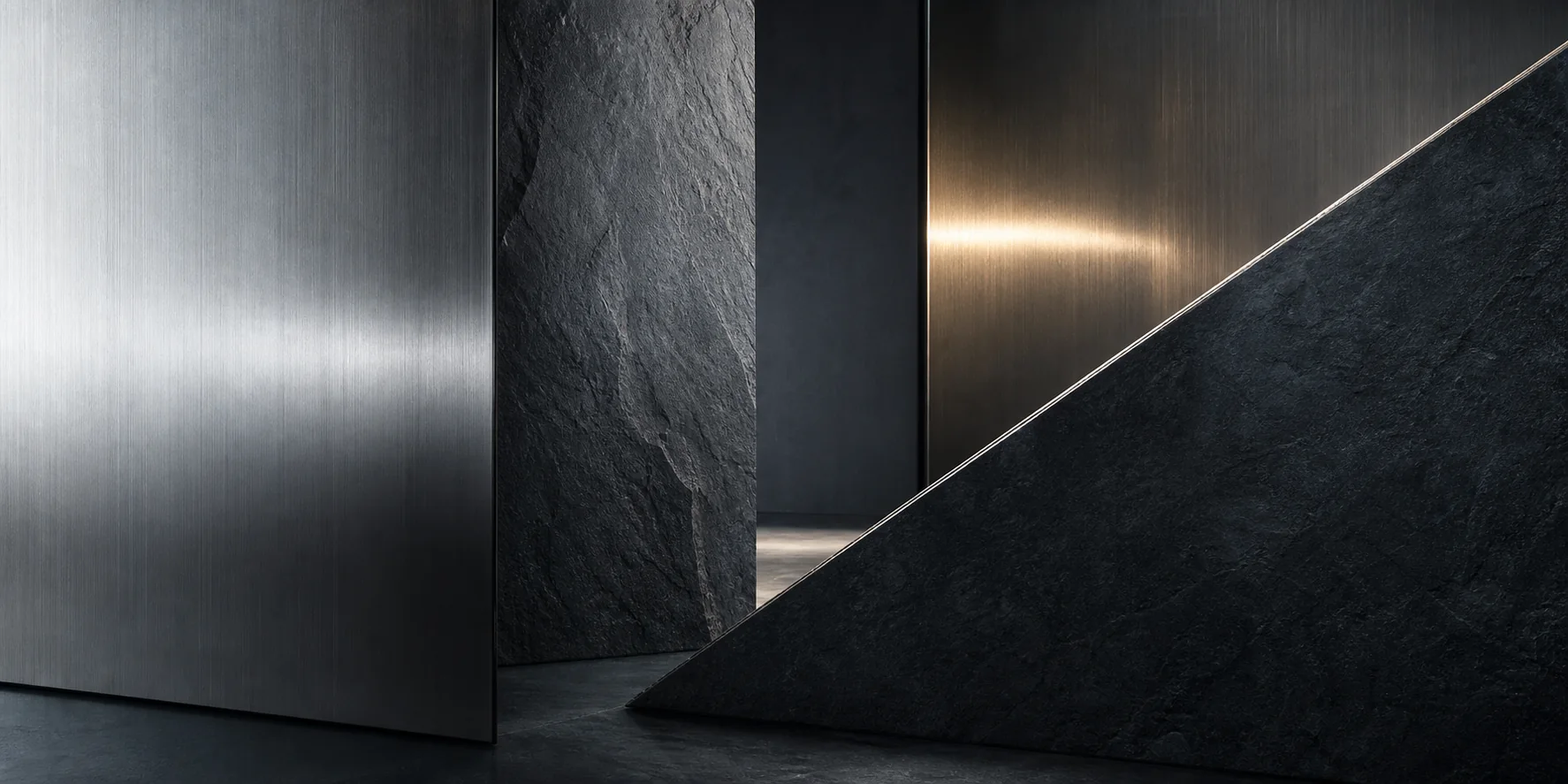Brushed metal and dark mineral surfaces arranged in a refined composition